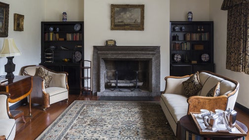 The Sitting Room at Coleton Fishacre, Devon, featuring the limestone fireplace